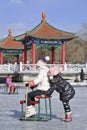 Tow girls have fun on the ice in Nanhu Park, Changchun, China